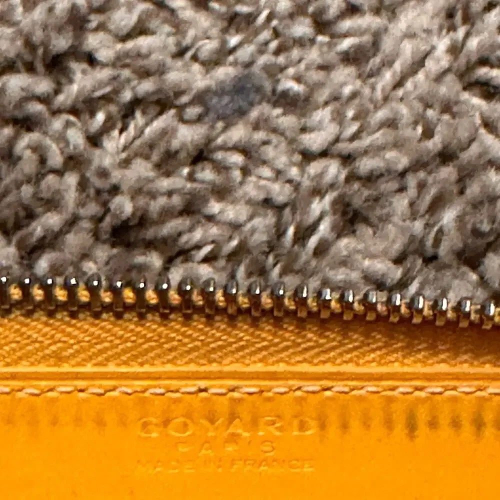 Goyard Matignon zip-around wallet in yellow orange Goyardine canvas.